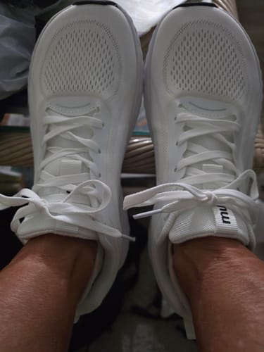 A customer's feet wearing the new white MUUV Flow Pickleball Shoes.