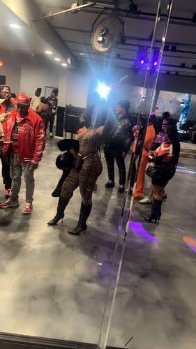 Customer in a leopard print Naked Print Closed Toe Jumpsuit, posing at an event.