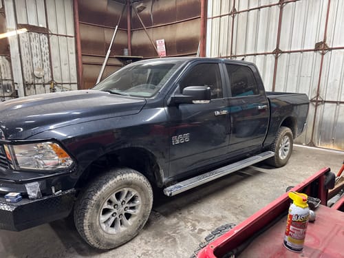 Customer's black Dodge Ram 1500 from the side after installing the 3" lift kit, showing its new stance.