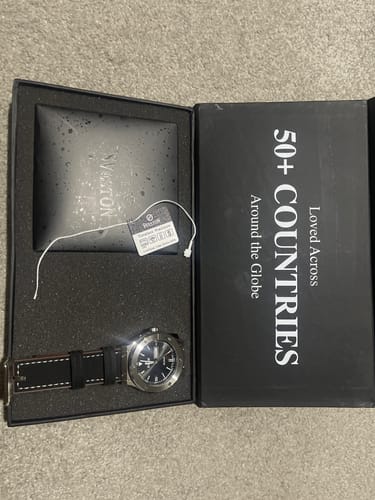 Customer's Selwar watch with a black strap, shown inside its original packaging.