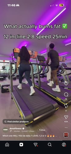 Reviewer on a treadmill at a gym, viewed from behind.