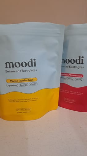 Customer's pouches of moodi Enhanced Electrolytes in Mango Passionfruit and Strawberry Watermelon flavors.