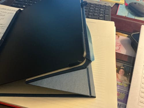 Reviewer's close-up of the Designer Solid iPad Case showing a cracked and chipped bottom corner on the plastic tray.