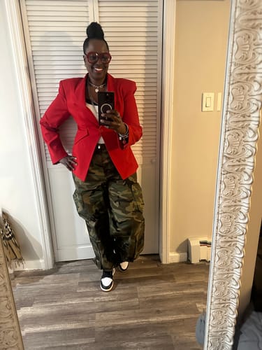 Reviewer taking a mirror selfie in the red Suited Sculpted Blazer, styled with camouflage pants.