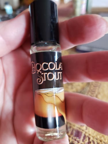 Reviewer holding the small rollerball bottle of Chocolate Stout scent.