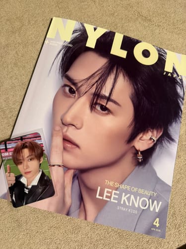 Customer's NYLON JAPAN magazine featuring Lee Know on the cover, shown with a bonus photocard.