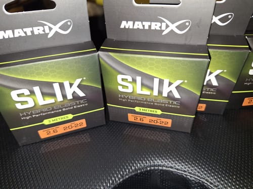 Klant toont de verpakking van meerdere Matrix Slik Elastic rekkers in maat 20-22.