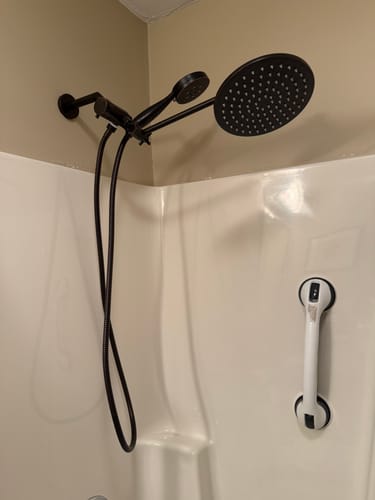 Customer's black Dual Shower Head Set installed in a white shower, showing the rain shower head and handheld sprayer.