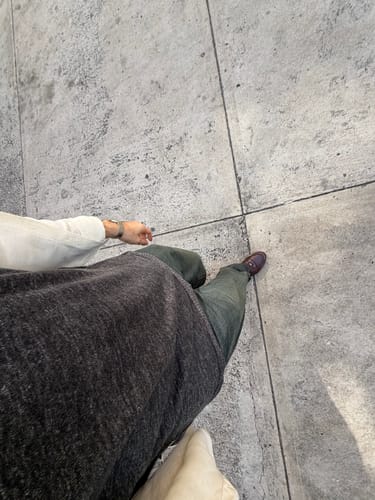 Reviewer's top-down view of the dark French Linen T-Shirt, showing its heavy texture and drape.