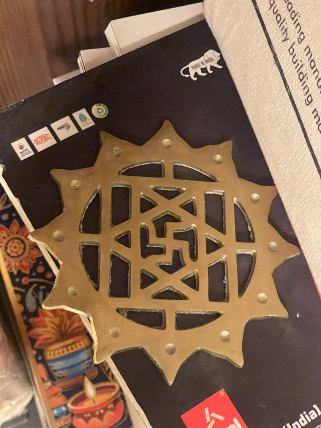 Customer photo review of Brass Swastik with Lotus Helix – Vastu Remedy for Main Door Protection | Evil Eye & Positive Energy Shield | Kitchen/Entrance Placement | 6 x 6 Inch