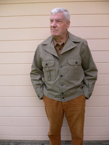 Reviewer wearing the green M-41 HBT Fatigue Jacket, showing a relaxed, comfortable fit outdoors.