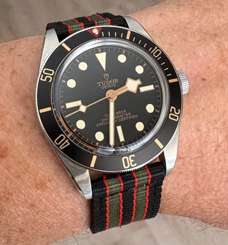 A customer's O2 Strap in the striped Vintage Bond color, shown on a watch with a black dial.
