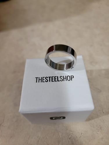 Customer's 6mm flat wedding band with a polished finish, displayed on its white box.