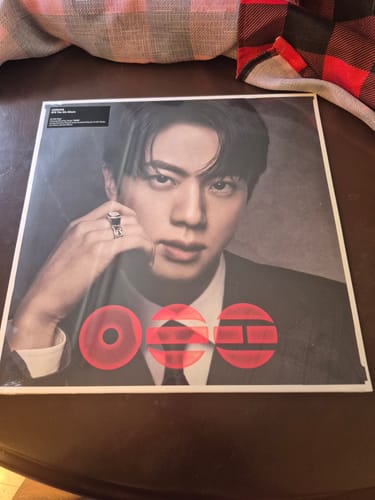 Customer's BTS ARIRANG 5TH ALBUM STANDARD VINYL, showing the Jin version cover resting on a wooden table.
