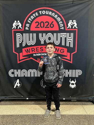 Customer photo of a young wrestler at a championship, where they used Cael's Cookies to refuel.