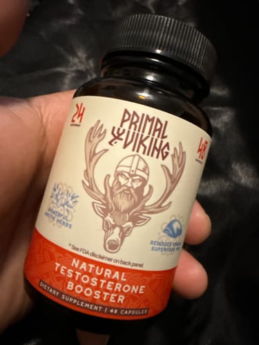 Customer holding the bottle of Primal Reindeer Testosterone Support, showing the front label.
