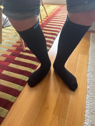 Customer wearing the black Performance Eucalyptus Compression Socks, showing the fit on their lower legs.