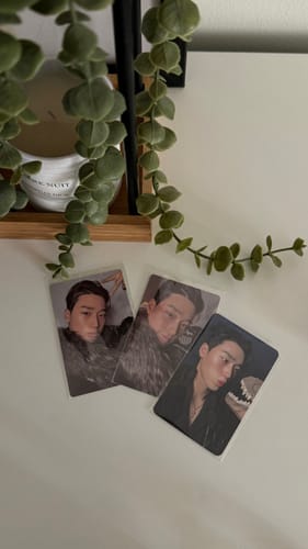 Customer's three ATEEZ 'GOLDEN HOUR : Part.4' photocards in protective sleeves, fanned out on a white surface.