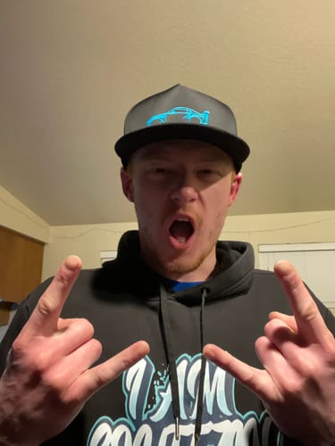 Customer wearing the dark 80Eighty® Limited Edition DCG#87 Hat, making an energetic gesture with both hands.