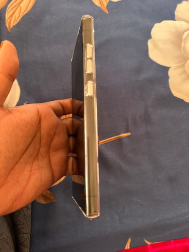 Customer holding their phone in the clear case, showing the side view with the power and volume buttons.