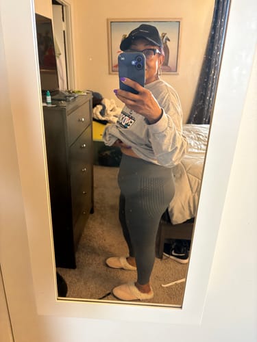 Customer's side-profile mirror selfie shows the fit of their grey 3D Anti-Cellulite Leggings.