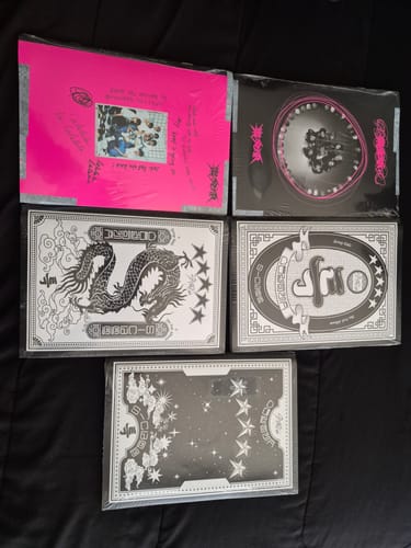 Reviewer's haul of five new K-pop albums, including multiple versions of the STRAY KIDS 5-STAR album, all sealed in plastic.