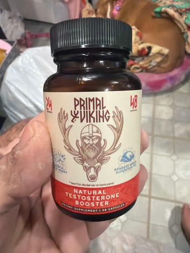 Customer's hand holding a bottle of Primal Viking Natural Testosterone Booster.