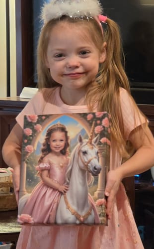 A customer smiling while holding a custom 'The Baby Unicorn Princess' canvas portrait.