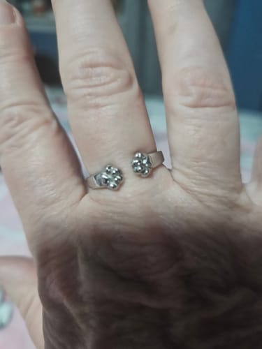 Reviewer wearing the silver Paw Hug Ring, showing how the two paw-shaped ends wrap around their finger.