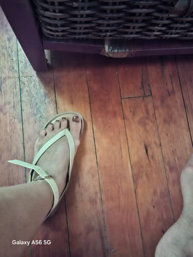 Reviewer's foot wearing the nude Viabeach Qork 11 Sandal on a wooden floor.