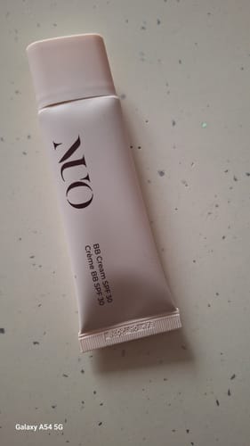 Customer's light pink tube of NUO BB Cream SPF30 lying on a countertop.