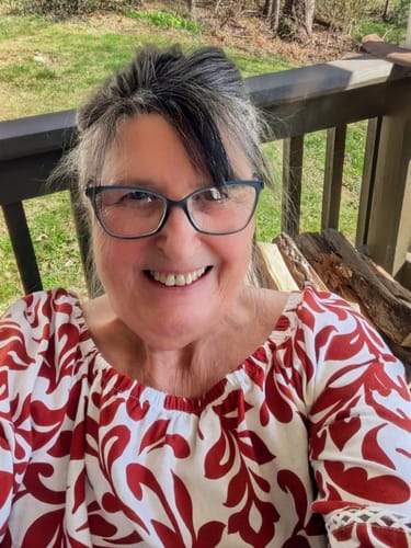 A customer who wrote a review for the Cherry Dosi-Do Pre-Roll smiles for a selfie outdoors.