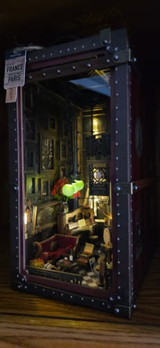 Customer's completed Eternal Midnight Paris Book Nook Kit, lit up to reveal a detailed, cozy jazz club interior.