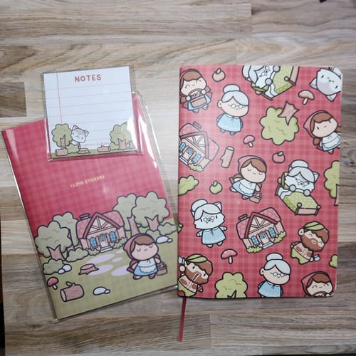 Customer's Red Riding Hood Set showing the illustrated mini journal, sticker album, and sticky notes on a table.