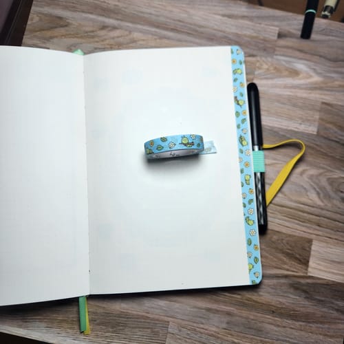 Customer showing the Cute Critters Washi Tape used for edging a journal page, with a roll resting on the notebook.