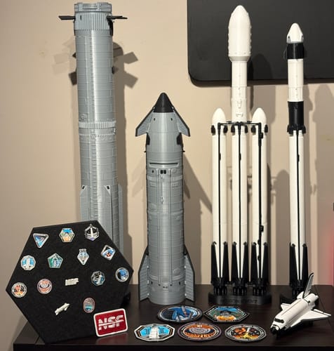 Customer's Starship Flight Pin Collection and Display Mount on a shelf, surrounded by a collection of model rockets.