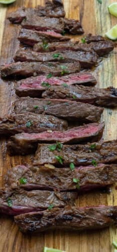 Customer's Wagyu Ranchera Carne Asada, sliced on a wooden board to show its tender pink center.