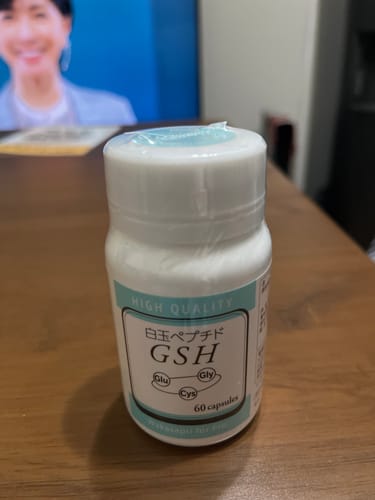 レビューアーがテーブルに置いた、ワカサプリ 白玉ペプチド（GSH）の白いボトル。