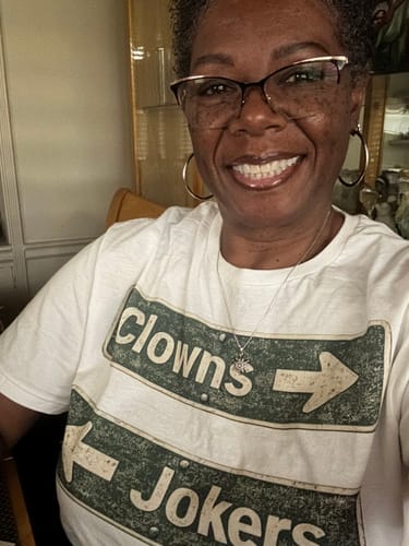 Reviewer smiling while wearing the white Clowns and Jokers Street T-Shirt.