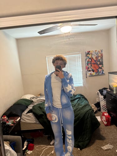 Reviewer wearing the light blue graphic SEEK VISIONZ SET in a mirror selfie in their room.