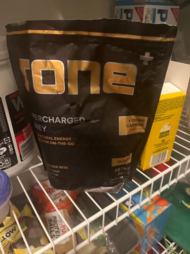 Customer's pouch of SuperCharged Honey sitting on a white wire shelf in a pantry.