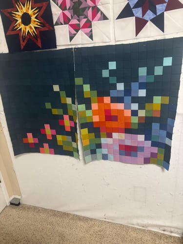 Customer's Tilda Embroidery Flower quilt in two large sections, showing the colorful pixelated design in progress.