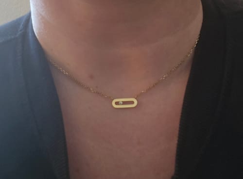 Reviewer shows a close-up of the Ellipse Pendant with Stone necklace worn on their neck.