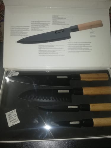 Customer's 4 Piece Japanese Kitchen Knives Set with black blades and wood handles in its open box.