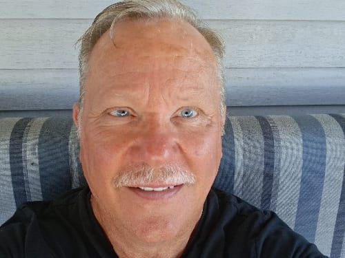 Customer smiling in a portrait submitted with their positive review of Protaflo.