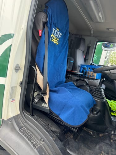 Customer's blue Waterproof Car Towel Seat Cover fitted onto the driver's seat of a work truck.