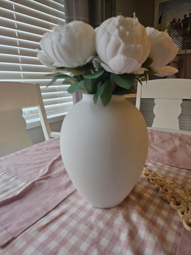Customer's matt white Ella Vase with white peonies, styled as a centerpiece on a dining table.