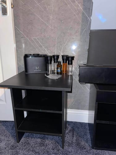 Customer's collection of ZenDuo Spare Heads with Bottles arranged on a black table for switching scents.