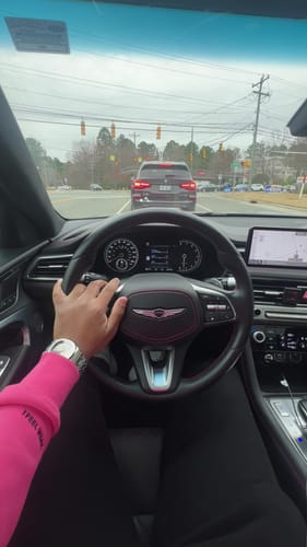 Reviewer wearing the silver Lucky Fours® Brone watch while driving a car.