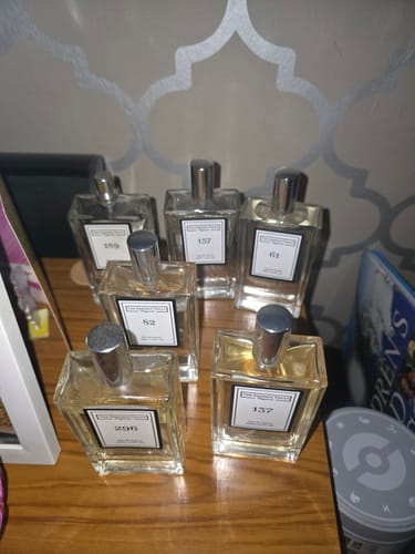 Customer's collection of six 100ml perfume bottles from the set arranged on a wooden surface.
